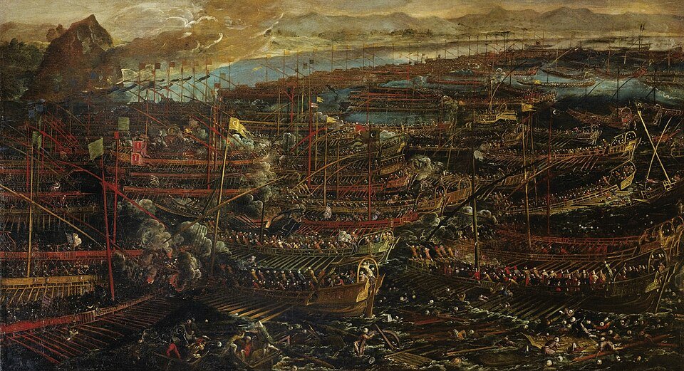 A dark oil painting of hundreds of oared galleys packed together in a bay, masts and banners crowding the horizon, men fighting on the decks and bodies in the water.