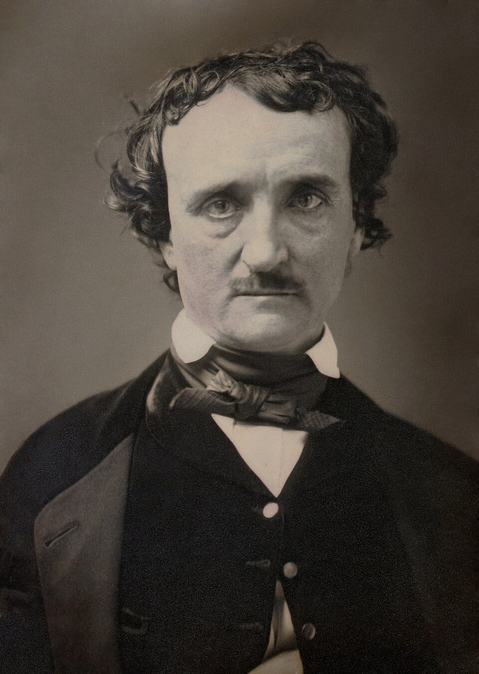 A daguerreotype portrait of a man with a high forehead, dark hair and a drooping moustache, in a dark coat and loosely knotted cravat, staring past the camera.
