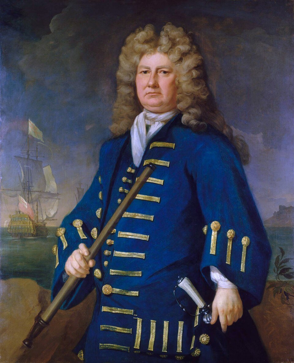 A painted portrait of a heavy-set man in a long curled wig and a blue naval coat with gold braid, holding a baton, with sailing warships on the sea behind him.